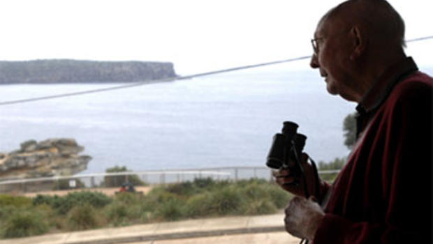 In this photo taken May 25, 2010, Don Ritchie looks out his window at his home in Sydney, Australia. For almost 50 years Ritchie, widely regarded as a guardian angel, has used simple kindness to shepherd countless suicidal people away from the edge.
